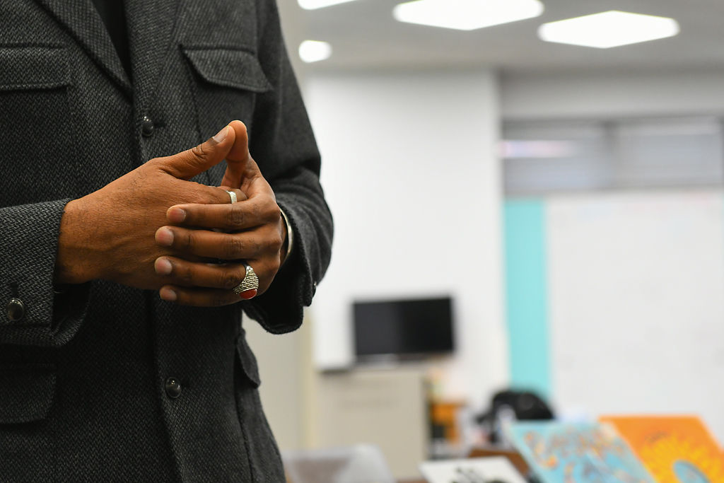 Khalid el-Hakim, curator and founder of the Black History 101 Mobile Museum, folds his hands together while speaking to students